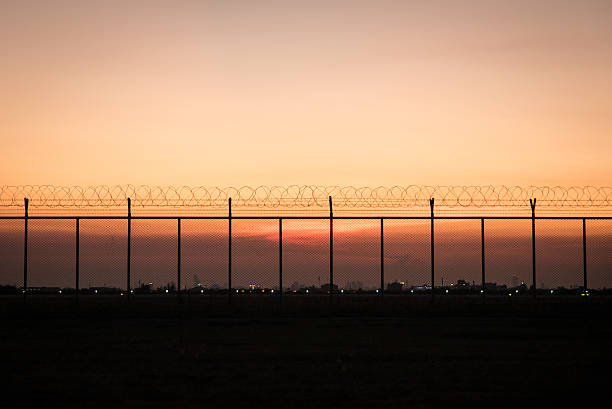 istock Dusk sky behind silhouette fence 532261736