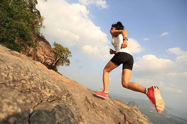 istock young woman trail runner running on mountain peak 532262282