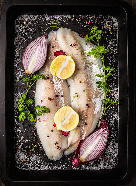 fish with spices,herb,onion,lemon  on backing tray