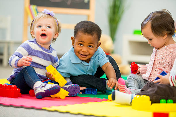 Babies Playing Diverse group of babies playing. toddler stock pictures, royalty-free photos & images