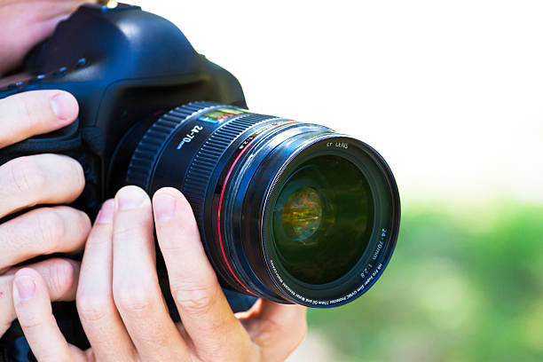 istock Closeup male Photographer holding DSLR camera, copy space 532263883