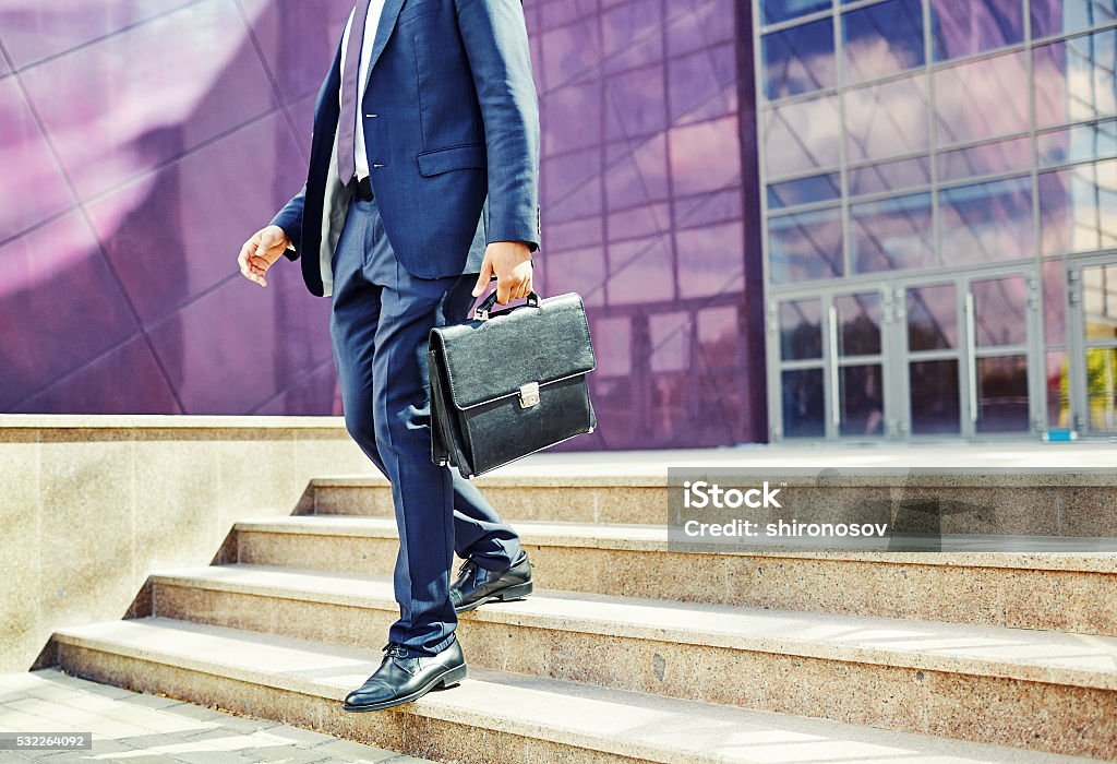 Man in the city Image of businessman leaving office building  Leaving Stock Photo