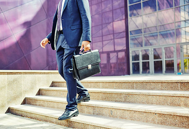 Man in the city Image of businessman leaving office building  office leave stock pictures, royalty-free photos & images