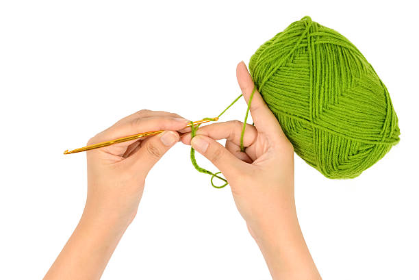 istock Crocheting with Green wool in hand 532265320