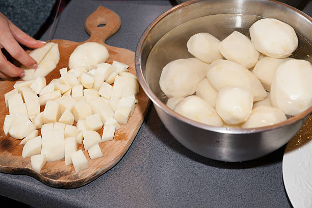 Chopped and whole potatoes stock photo