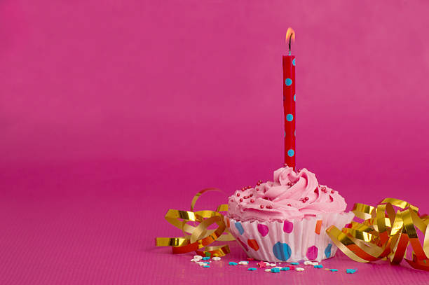 istock Delicious birthday cupcake on pink background 532270704