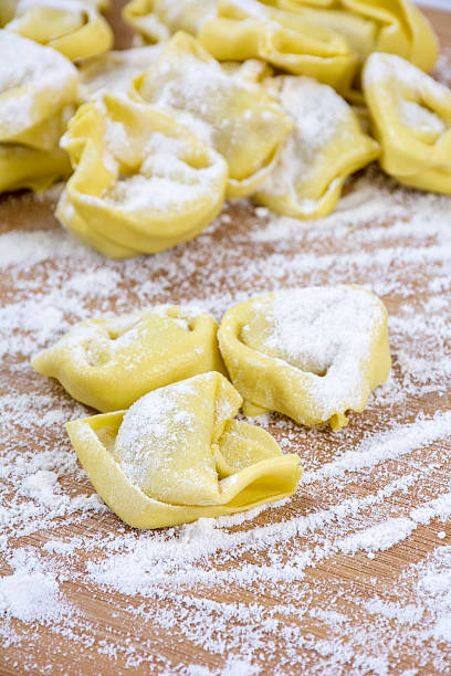 istock Several yellow ravioli on the wooden table with flour 532271360