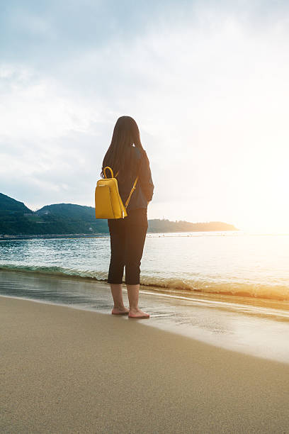 istock young woman looking at the ocean 532271434