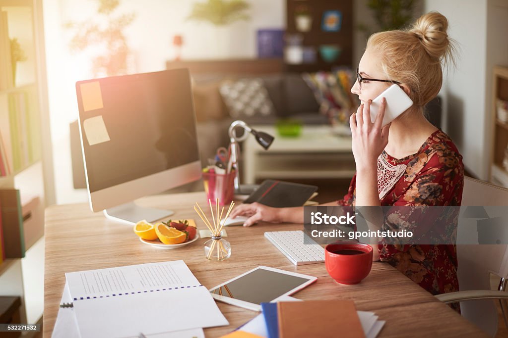 Woman in surroundings of digital technology Working At Home Stock Photo