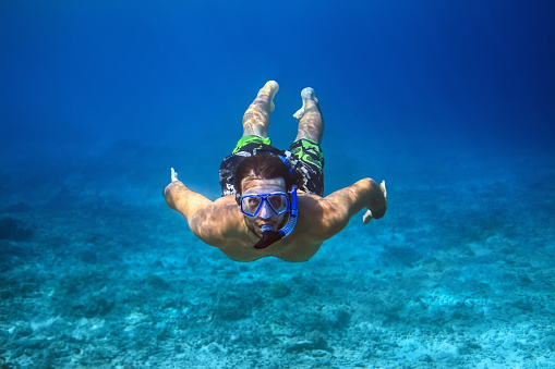 Underwater shoot of a young man snorkeling in a tropical sea. vacation concept