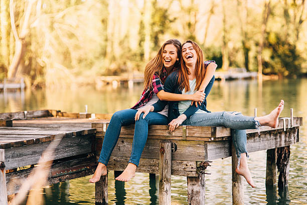 Young women sitting on the pier 