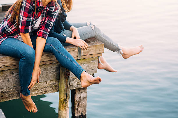 istock Young women sitting on the pier 532275160
