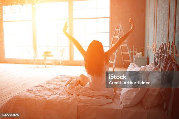 Woman Stretching In Bed After Wake Up Stock Photo - Download Image Now - Rear View, Women, Happiness