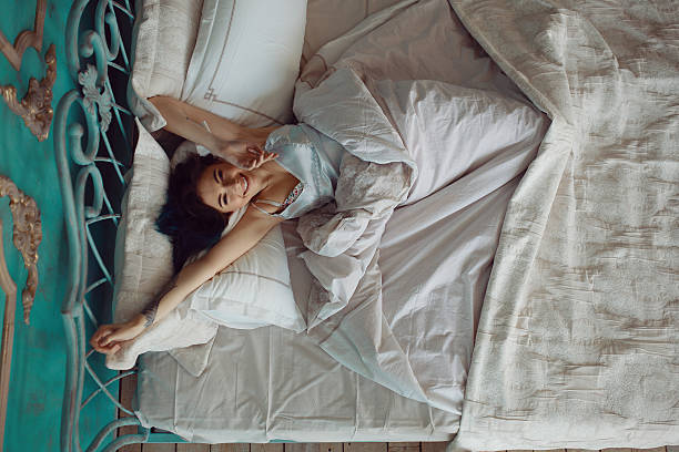 istock Woman stretching in bed after wake up 532275626