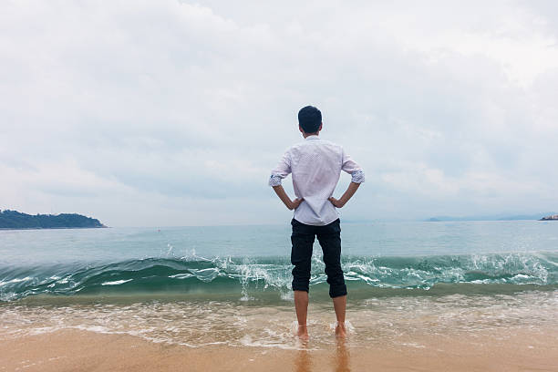 istock Young man standing on the beach 532275858