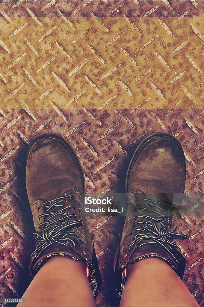 metal plate with feet in leather boots feet with leather boots on a metal plate Arts Culture and Entertainment Stock Photo