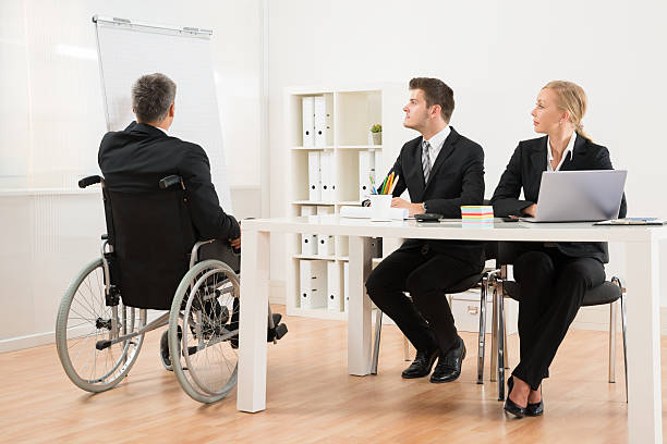 istock Handicapped Businessman Explaining To His Colleagues 532279736