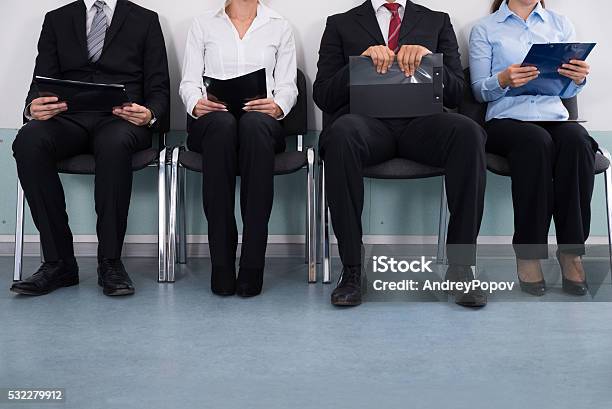 Businesspeople Sitting On Chair Stock Photo - Download Image Now - Unemployment, Unemployment Office, Job Interview