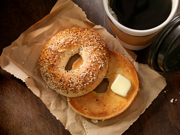 Toasted Bagel with Butter Toasted Bagel with Butter and a Take out Coffee - Photographed on a Hasselblad H3D11-39 megapixel Camera System PLAIN BAGEL stock pictures, royalty-free photos & images