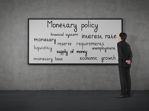 Businessman think about monetary policy at the blackboard