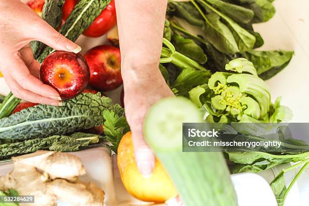 She Is Preparing Vegetables With An Out Of Focus Cucumber Stock Photo - Download Image Now