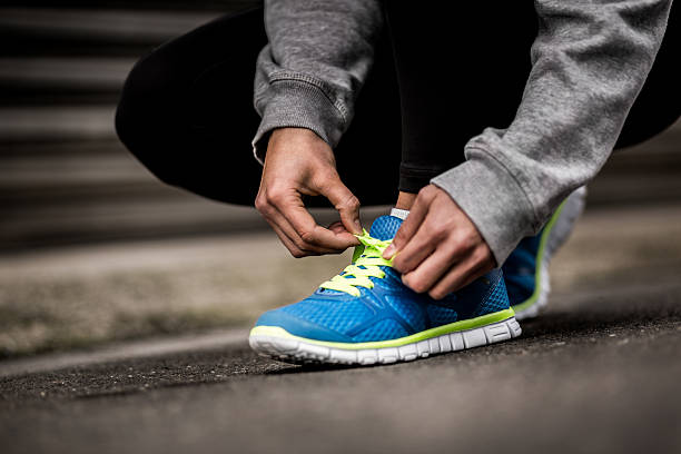 istock Runner Tying Shoelaces In The Road 532286115