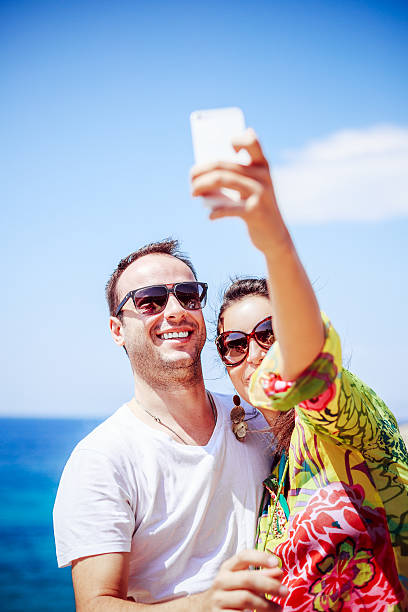 istock Gorgeous smiled couple taking selfie with smartphone exotic summer holiday 532286177