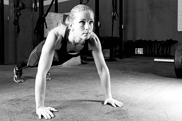 istock young woman making pushups - gym workout 532286929