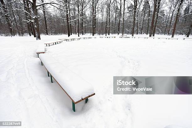 Snow Covered Public Area With Benches In City Park Stock Photo - Download Image Now - 2015, Agricultural Field, At The Edge Of