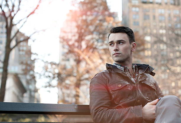 istock Young Man Sitting on a City Park Bench 532288117