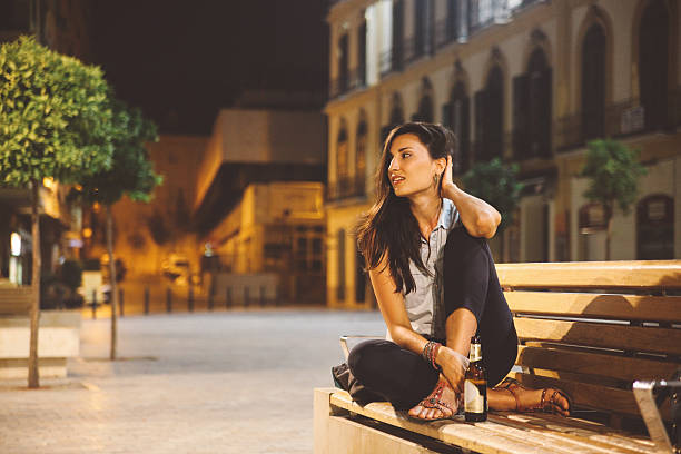istock young woman relaxing in evening on the bench 532289409
