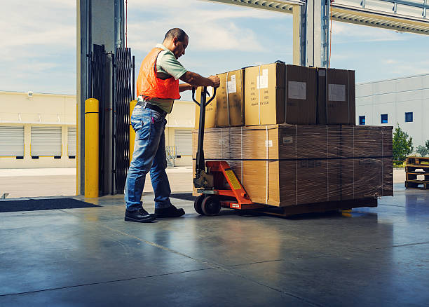 istock worker with hand pallet truck 532298617