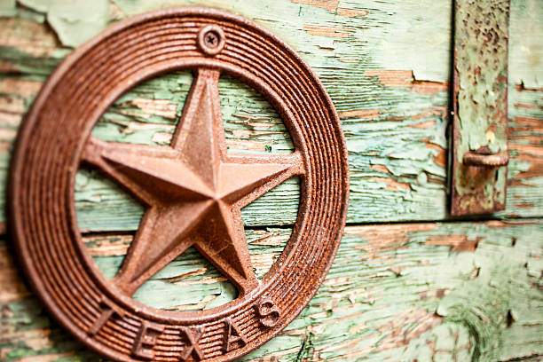 Old green box, chest with peeling paint and hasp.  Iron Texas star emblem on front.