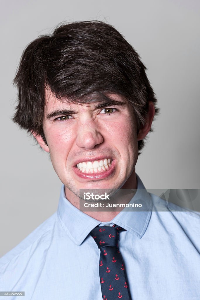Displeased Young man (real people) Displeased young man (real people) on gray background 20-24 Years Stock Photo