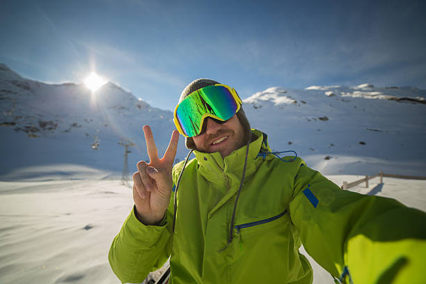 istock Skier man taking selfie on ski slopes-Sunset time 532299081