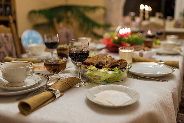 Traditional Christams Eve table with Polish tradishional courses like dried plum compote, different fish. In the sopu plate there are mashroom dumplings wich are served with borscht as the first dish in that evening.