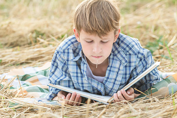 istock Teenage boy lying with book 532302141