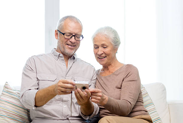 istock happy senior couple with camera at home 532302289