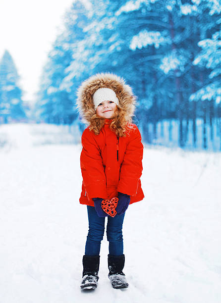 istock Child with heart in hands outdoors 532304335