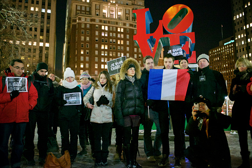 Philadelphia, PA, USA - January 9, 2015; French Philadelphia area residents stand near the Love statue at JFK Plaza in Philadelphia, PA during a vigil held in support for freedom of speech. (photo by Bas Slabbers)