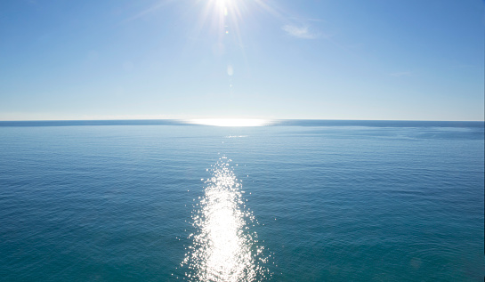 Beautiful clear ocean with sun reflection in sunny day, southern Thailand. Tropical summer beach holiday, nature concept.