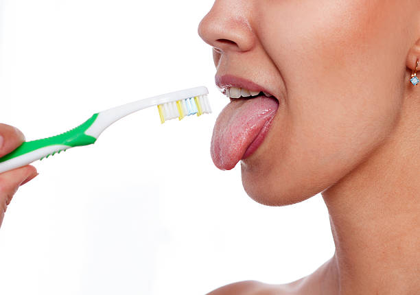 Photo Of Young Woman Cleaning Tongue With Cleaner