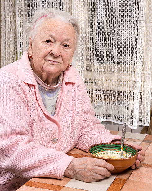 istock Old woman eating at home 532318409