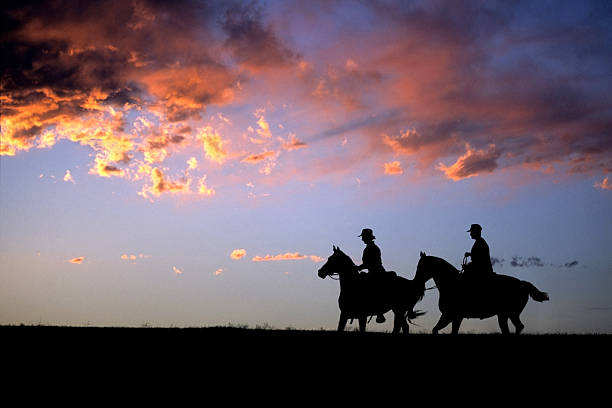 istock Colorado sunset silhouette horseback riders copy space 532318473