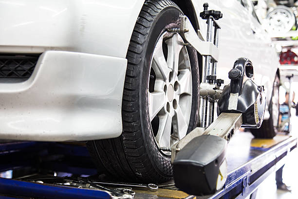 Wheel alignment of automobile Wheel alignment of automobile with focus placed on the wheel and equipment. car boot stock pictures, royalty-free photos & images