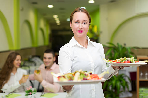 istock Waitress serving food to visitors 532320027