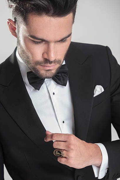 istock elegant young man in tuxedo looking down 532320725