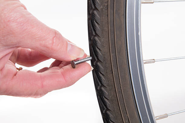 Nail stuck in the tire of the bike stock photo
