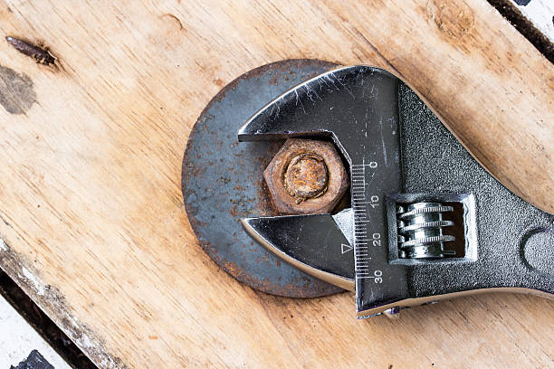 Pliers and nut on a wooden floor. Pliers and nut on a wooden floor. knurl stock pictures, royalty-free photos & images