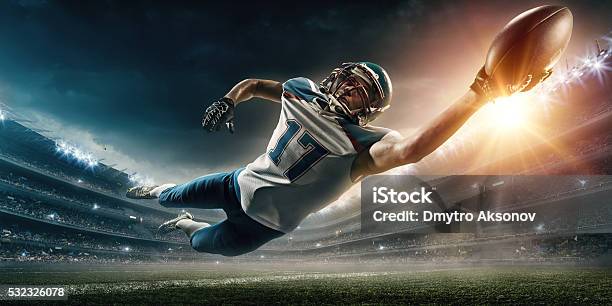 American Football Player Jumping Stock Photo - Download Image Now - American Football - Ball, American Football - Sport, Football Helmet
